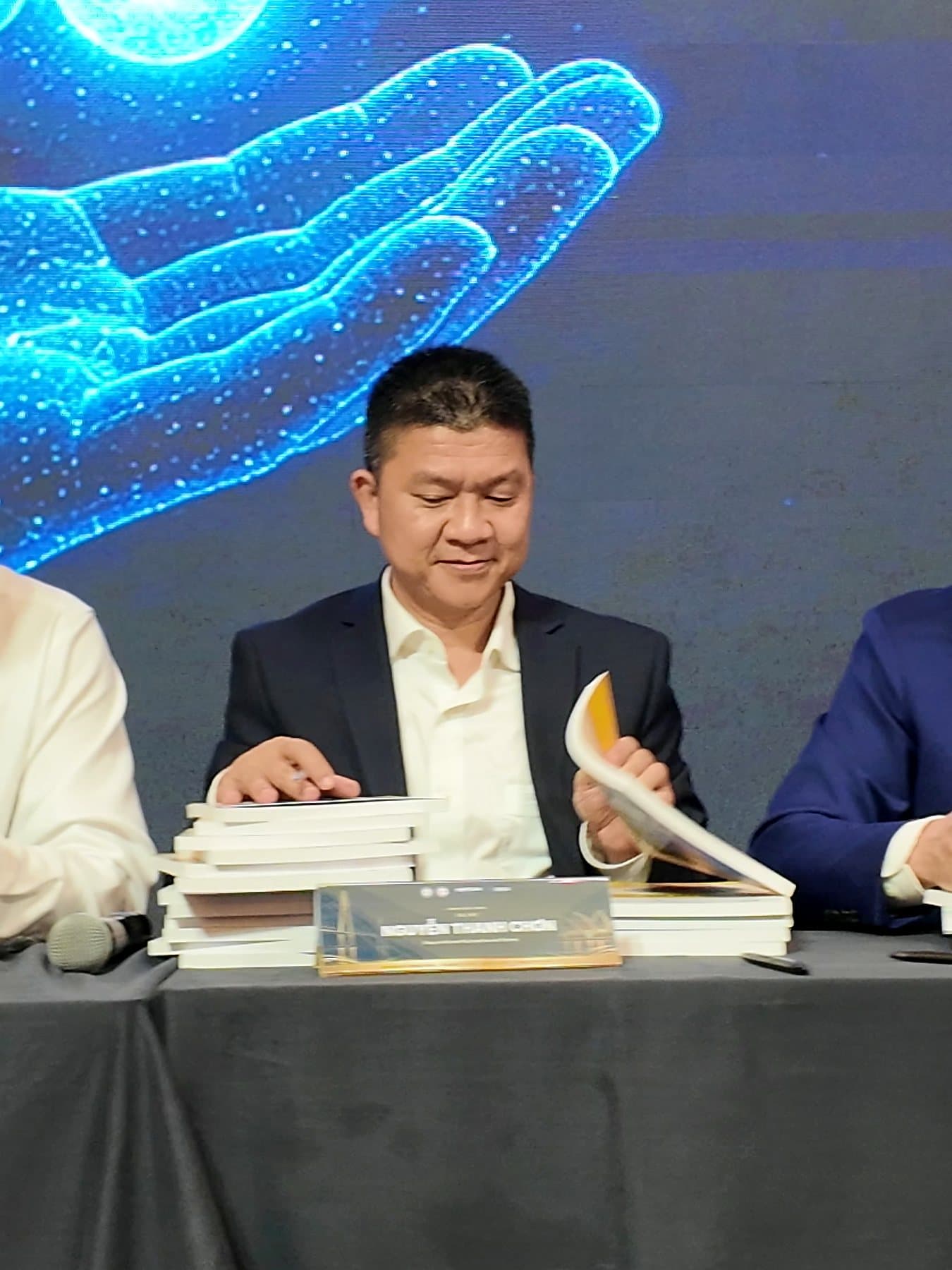 An author signing copies at the textbook launch